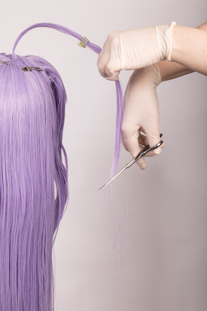 scissors cutting the tips on a wig