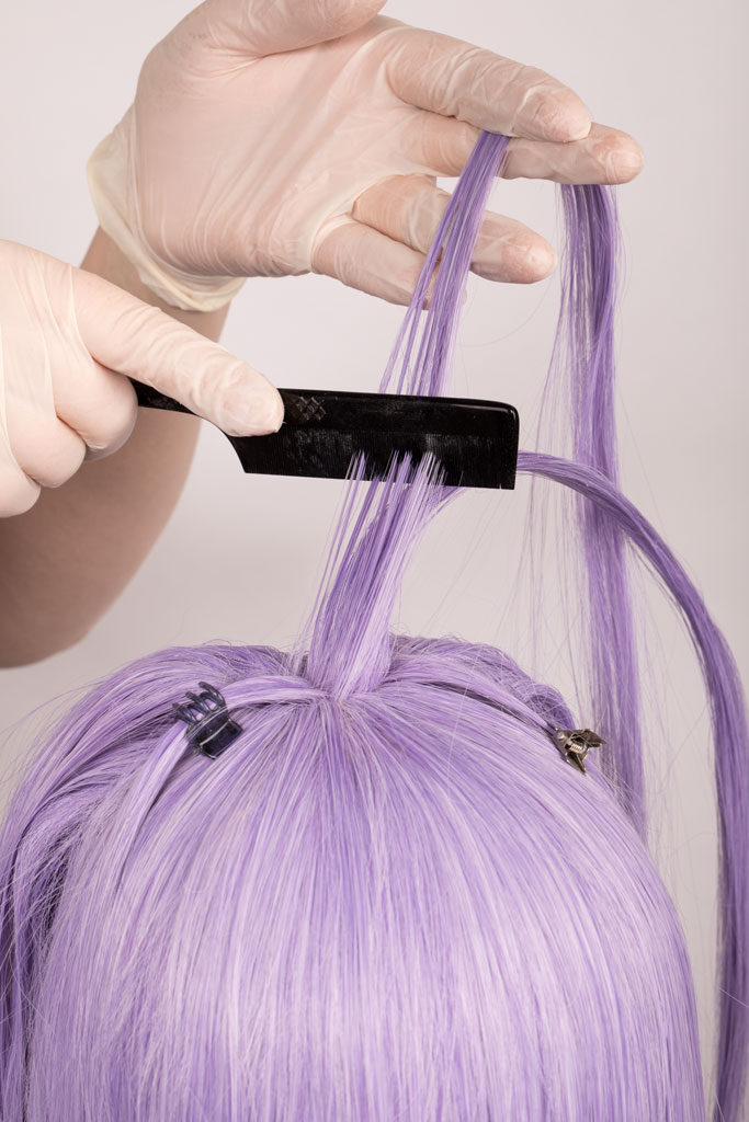 fine comb brushing through wig hair