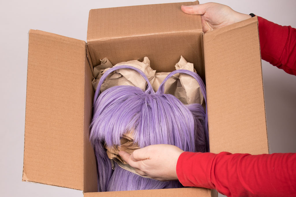 styled wig in a cardboard box