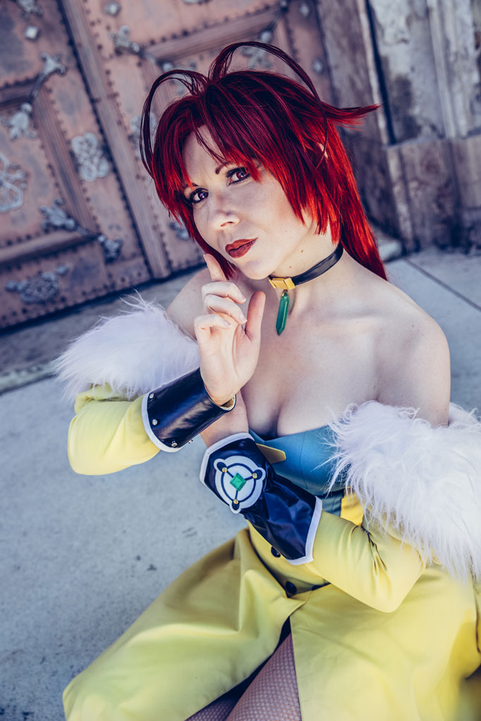 cosplayer wearing a yellow dress and a red wig